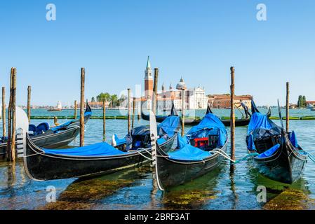 Pier with gondolas near Saint Mark`s Square in Venice, Italy. The gondola is a traditional romantic transport in Venice. Stock Photo